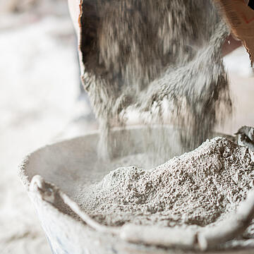 Filling a bucket with cement at construstion site